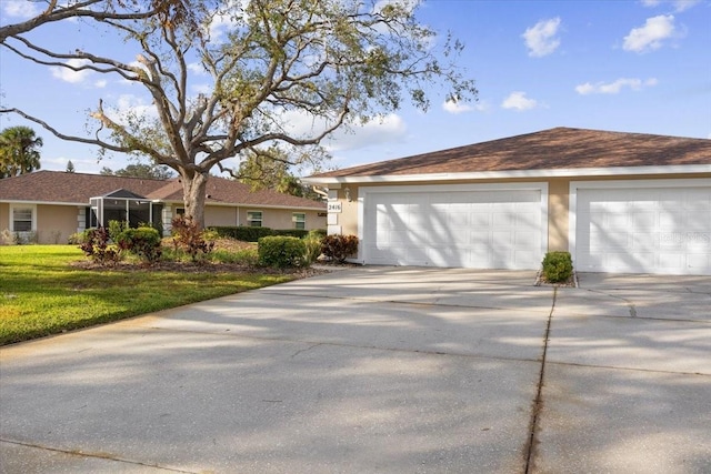 ranch-style home with a front yard and a garage