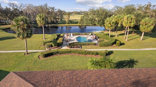 view of home's community with a swimming pool, a lawn, and a water view