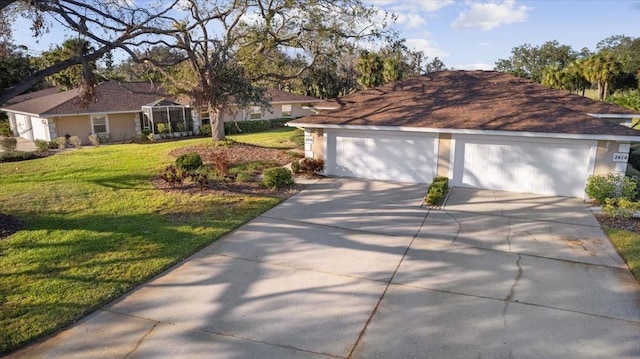 view of front of property featuring a front lawn and a garage