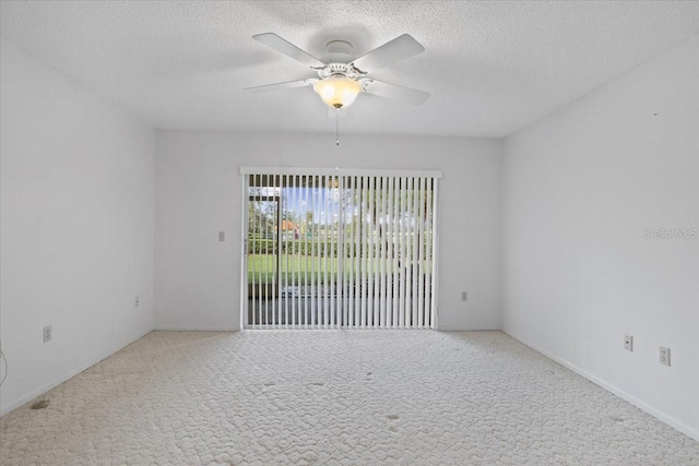 unfurnished room featuring carpet floors, a textured ceiling, and ceiling fan