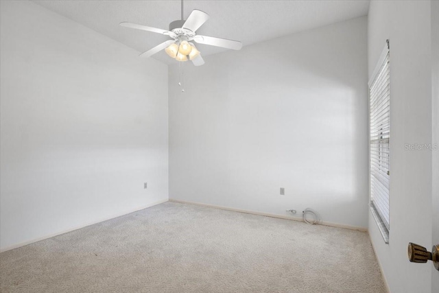 carpeted spare room with ceiling fan