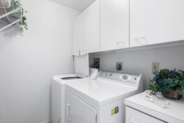 laundry area featuring cabinets, independent washer and dryer, and a textured ceiling