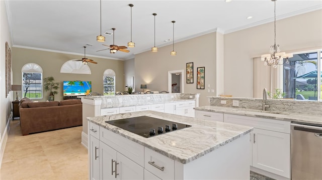 kitchen with plenty of natural light, stainless steel dishwasher, black electric stovetop, and a center island