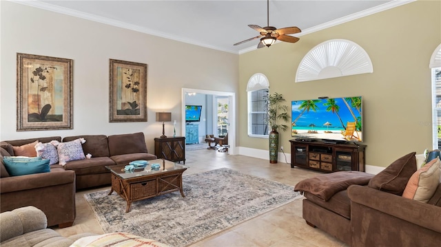 living room with a high ceiling, ceiling fan, and ornamental molding