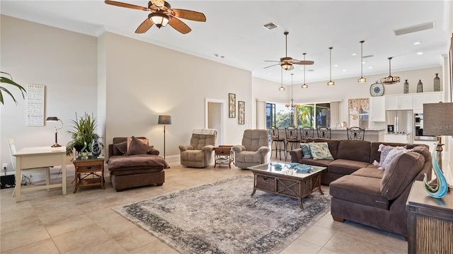 living room featuring ornamental molding, light tile patterned flooring, and ceiling fan