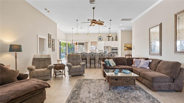 living room with ceiling fan, light tile patterned floors, and ornamental molding