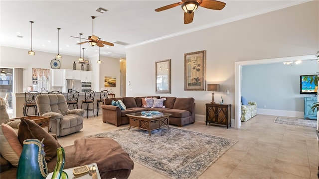 living room featuring ceiling fan and crown molding