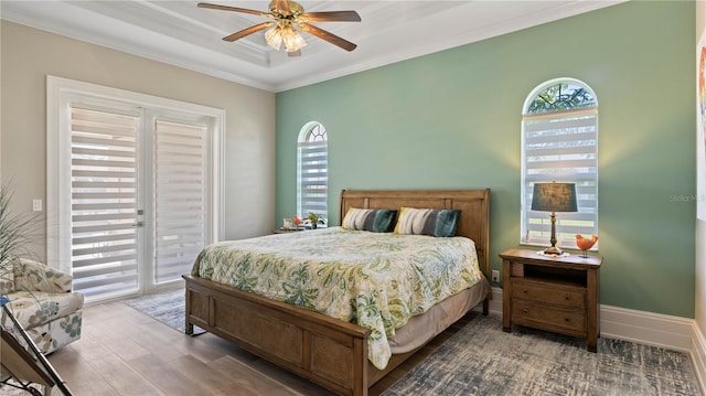 bedroom with ceiling fan, access to exterior, dark hardwood / wood-style floors, and ornamental molding