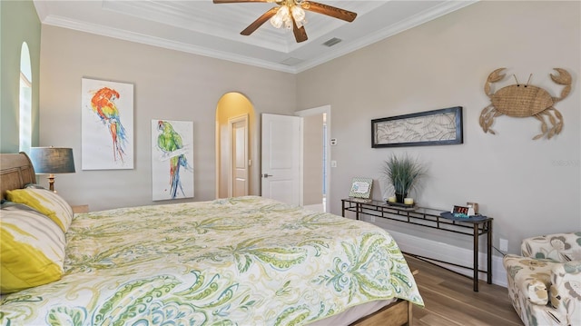 bedroom with wood-type flooring, ceiling fan, and crown molding