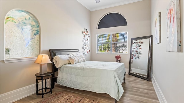 bedroom with light hardwood / wood-style flooring and ornamental molding