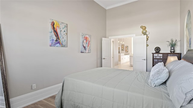 bedroom with crown molding and light hardwood / wood-style flooring