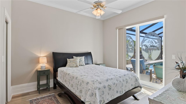 bedroom with ornamental molding, hardwood / wood-style flooring, ceiling fan, and access to exterior