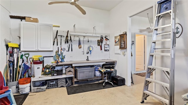 garage with a workshop area and ceiling fan