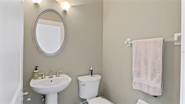 bathroom featuring toilet and sink