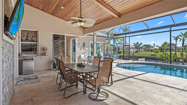 view of swimming pool featuring a patio, a lanai, and ceiling fan