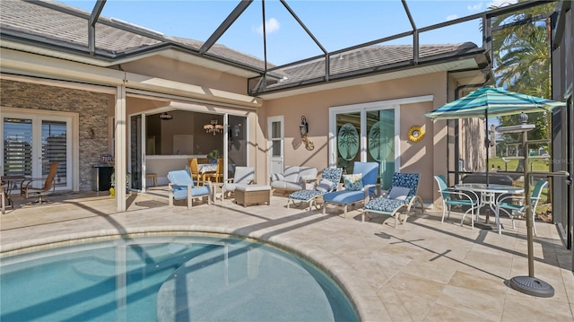 view of pool with a lanai, a patio, and an outdoor living space