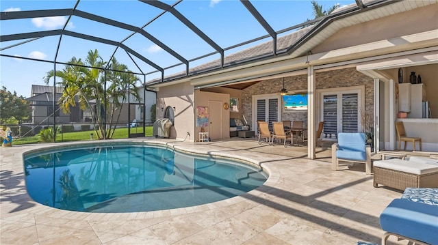 view of swimming pool featuring glass enclosure and a patio area