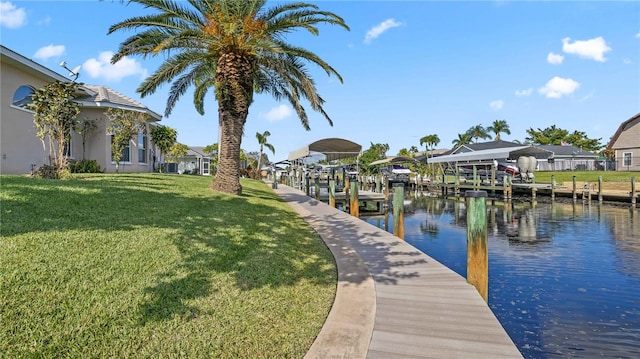 dock area with a water view and a lawn