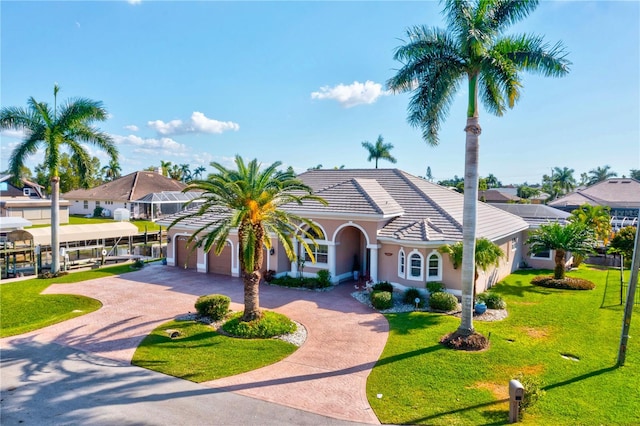 view of front of home with a garage and a front lawn