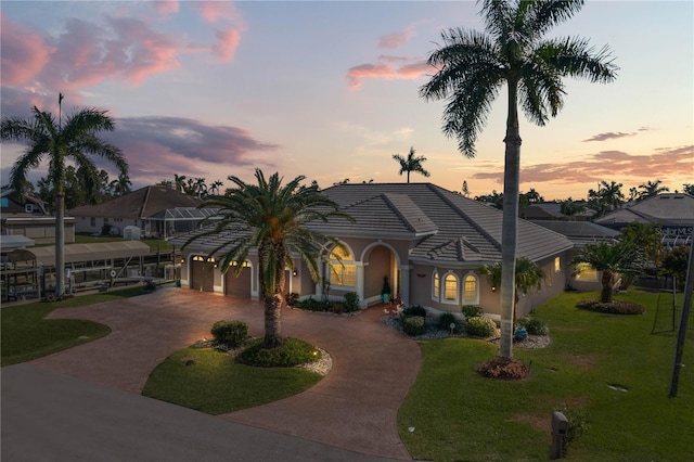 view of front of house featuring a garage and a yard