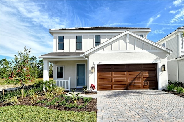 view of front of home featuring covered porch and a garage