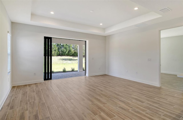 spare room featuring a tray ceiling