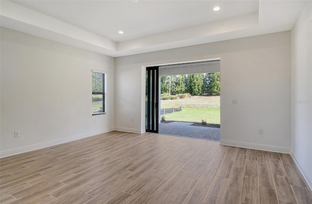 unfurnished room featuring a raised ceiling