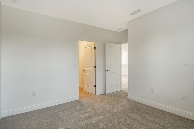 unfurnished bedroom with light colored carpet