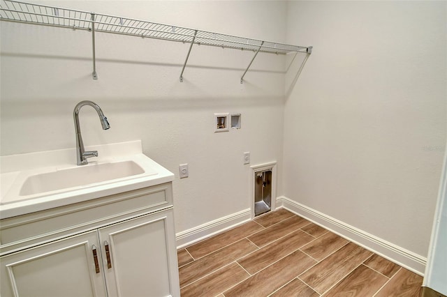 clothes washing area featuring cabinets, hookup for a washing machine, electric dryer hookup, and sink