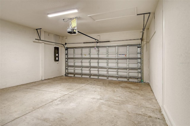 garage featuring electric panel and a garage door opener