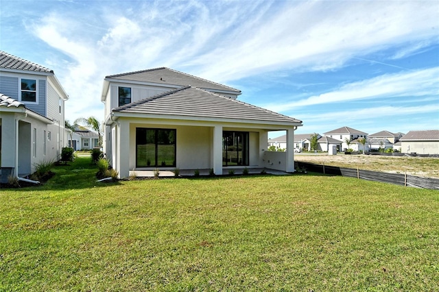 back of house featuring a yard