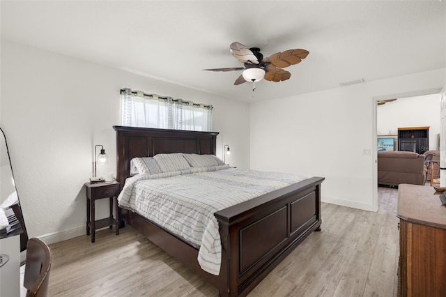 bedroom with ceiling fan and light hardwood / wood-style flooring