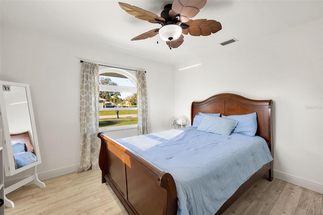 bedroom with light hardwood / wood-style floors and ceiling fan