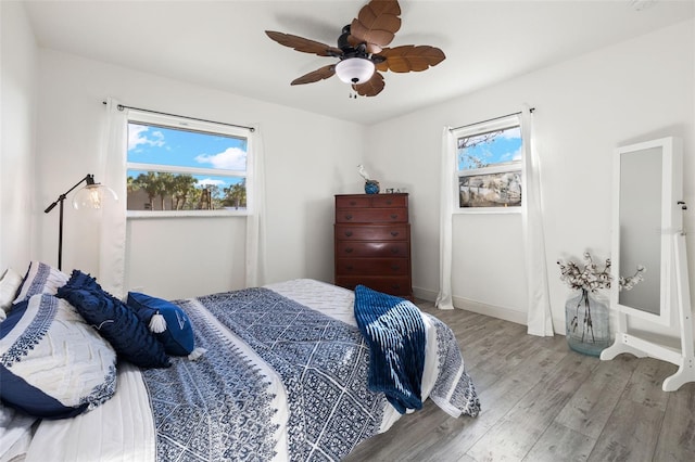 bedroom with ceiling fan and wood-type flooring