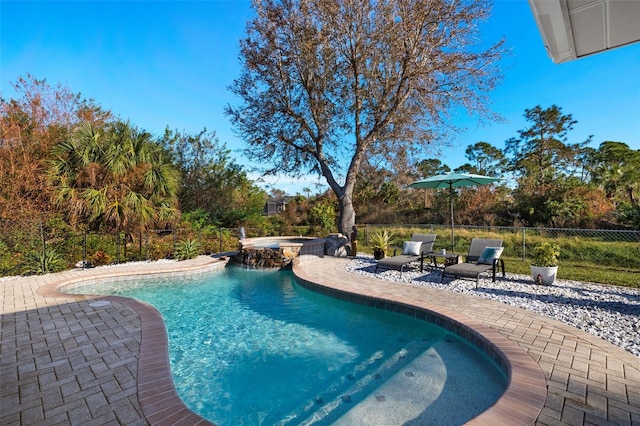 view of pool featuring a patio area and an in ground hot tub