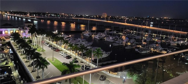 balcony at twilight featuring a water view