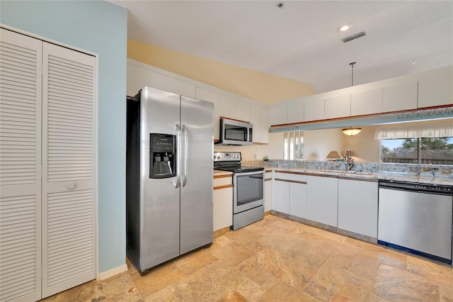 kitchen featuring white cabinetry, sink, and appliances with stainless steel finishes