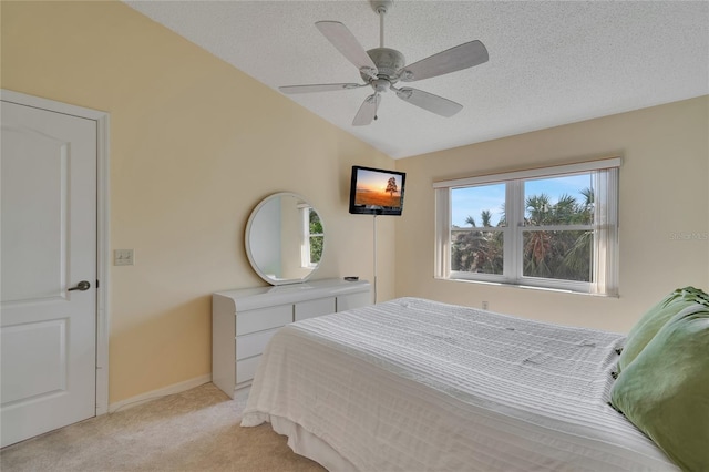 carpeted bedroom with a textured ceiling, ceiling fan, and lofted ceiling