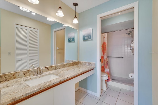 bathroom featuring tile patterned flooring, vanity, curtained shower, and toilet