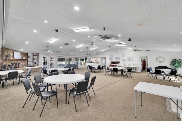 carpeted dining room featuring vaulted ceiling and ceiling fan