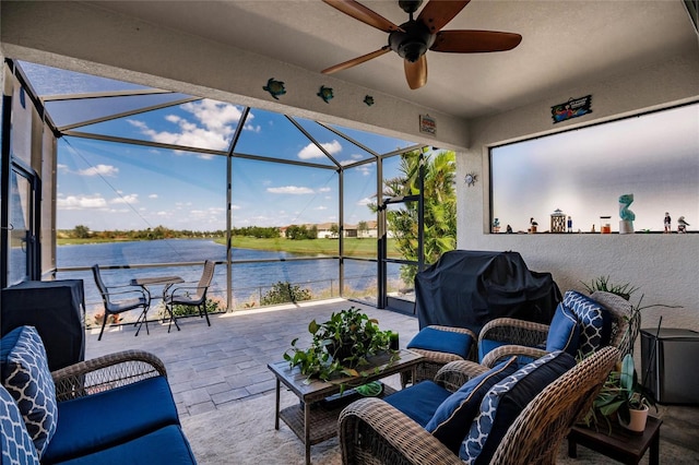 view of patio / terrace with glass enclosure, ceiling fan, a water view, and grilling area