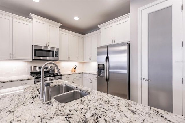 kitchen with white cabinets and appliances with stainless steel finishes