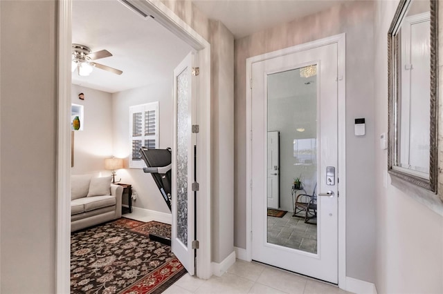 interior space with light tile patterned floors and ceiling fan