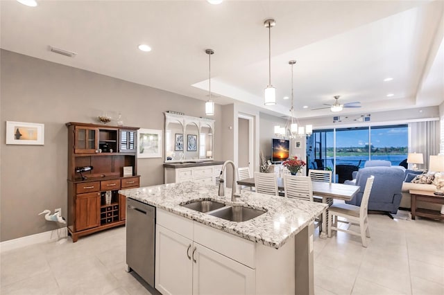 kitchen featuring dishwasher, sink, hanging light fixtures, ceiling fan, and white cabinetry