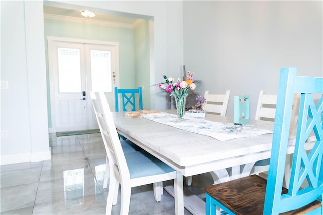 dining space with crown molding and french doors