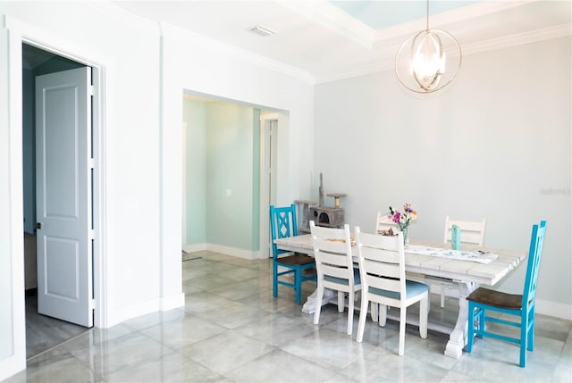 dining area featuring ornamental molding and an inviting chandelier