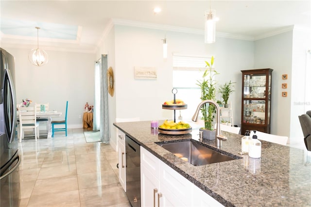 kitchen featuring white cabinetry, sink, hanging light fixtures, and dark stone counters