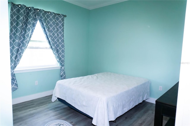 bedroom with dark hardwood / wood-style floors