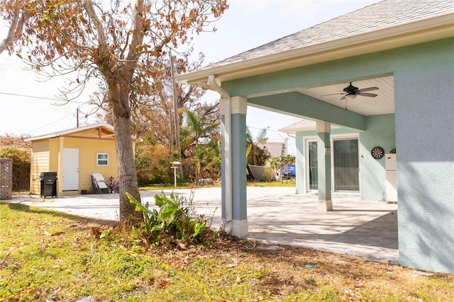 view of yard featuring a patio area and ceiling fan