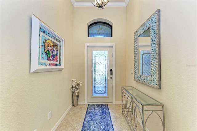 foyer entrance featuring crown molding, a notable chandelier, and light tile patterned floors